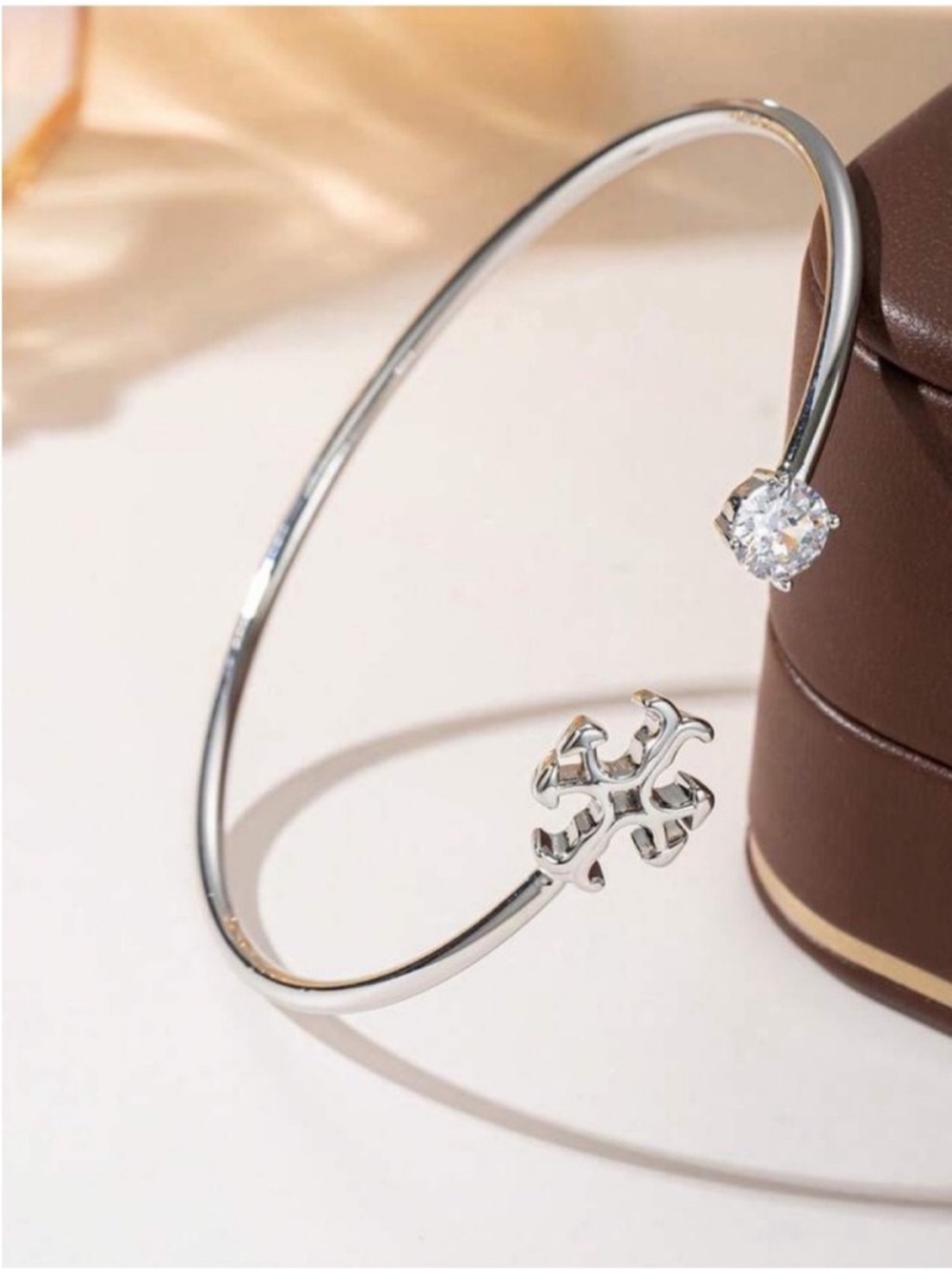 Tory Burch Silver Open Bangle Bracelet with Clear Stone and Cross Accent - Picture 2 of 2
